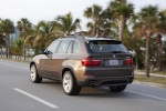 2013 BMW X5 xDrive50i in Sparkling Bronze Metallic - Driving Rear Left Three-quarter View